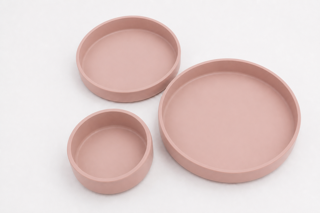 Juego de tres platos de silicona en color rosa clarito, mostrados en sus tres tamaños